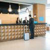 hotel confirmation Businessman making booking at front desk with Latin receptionists in hotel lobby